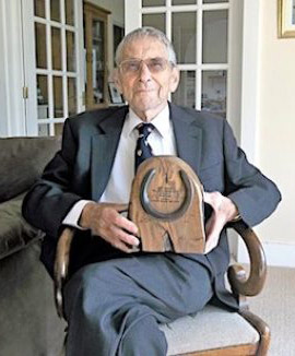 Dr Peter Rossdale holding his BEVA Equine Welfare Award